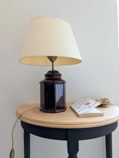 Lampe vintage octogonale en céramique bordeaux avec abat-jour crème sur console en bois