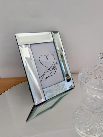 Cadre photo miroir vintage à bords biseautés en quinconce, dos en velours noir et pied incliné, style Art déco.