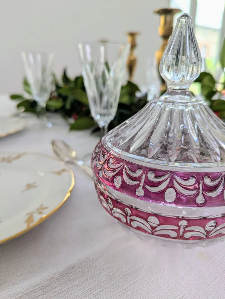 Composition de matières pour une table de Noël chic : cristal, métal argenté, laiton doré et porcelaine