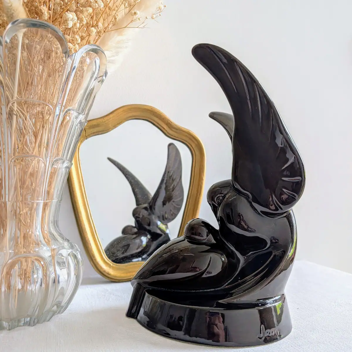 Reflet d'une sculpture oiseaux vintage dans un miroir ancien