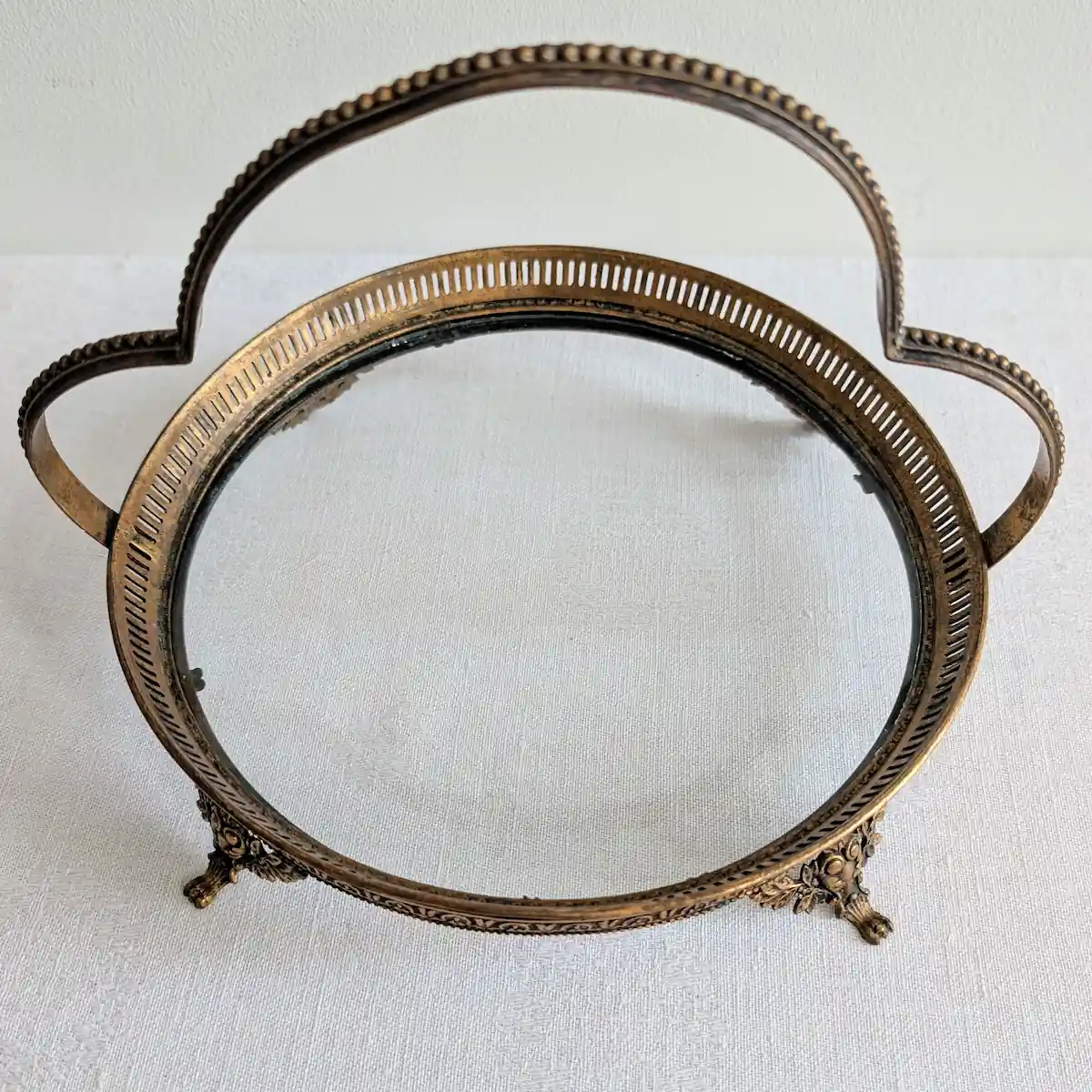 Vue de dessus du plateau circulaire ancien en verre et laiton