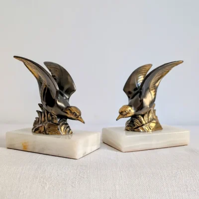 Paire de serre-livres oiseaux en métal doré et socle onyx Art déco