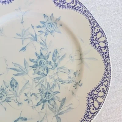 Gros plan sur le motif floral et la frise en dentelle Creil et Montereau