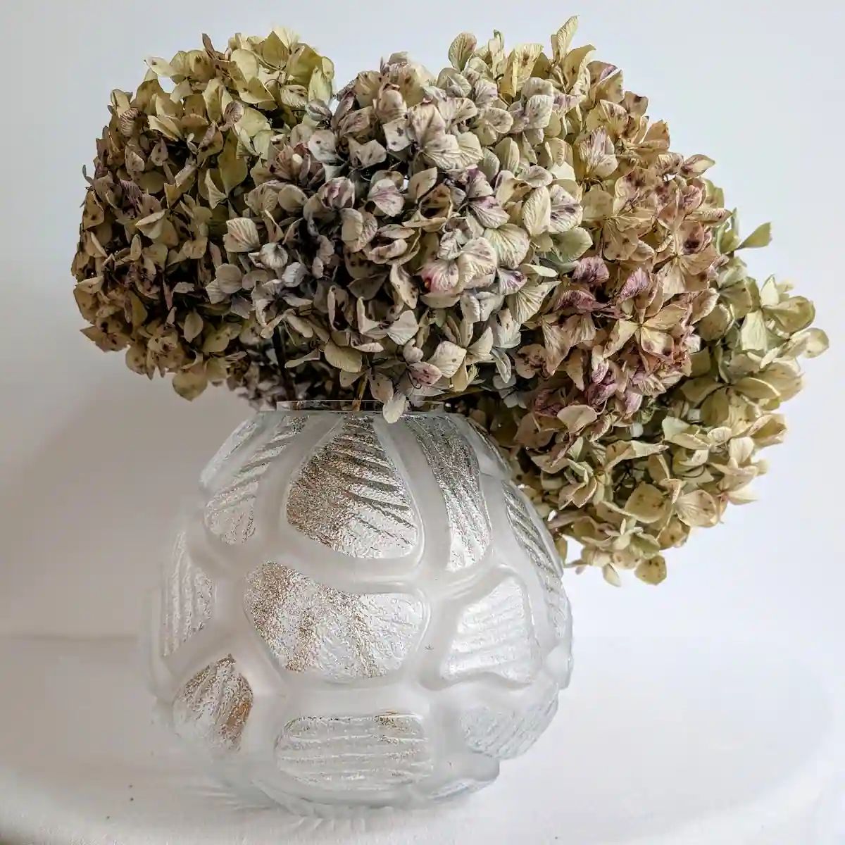 Grand vase boule en verre rempli de bouquets de fleurs séchées pour une décoration d'intérieur