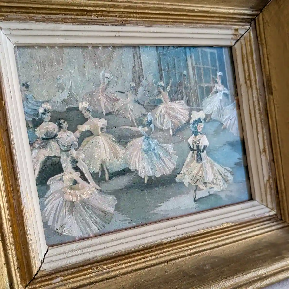 Gros plan sur les moulures dorées patinées et l’entourage crème du tableau de ballet Henri de Nac.