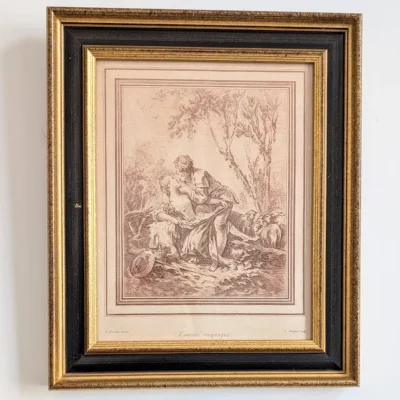 Gravure L’Amitié réciproque d’après Boucher, encadrée dans une baguette noire et dorée.