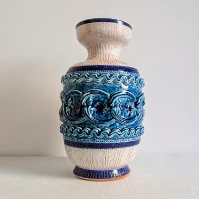 Vue de face d'un grand vase ancien en céramique émaillée aux motifs géométriques en relief bleu cobalt